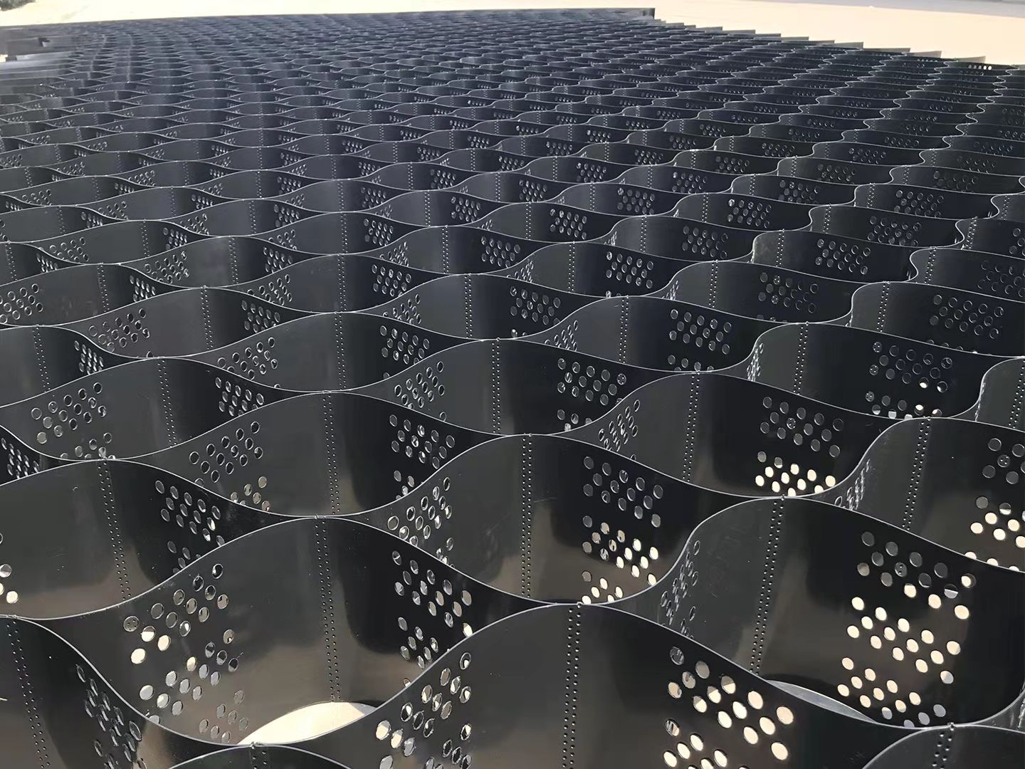 Textured and Perforated HDPE Geocells for Slope Protection